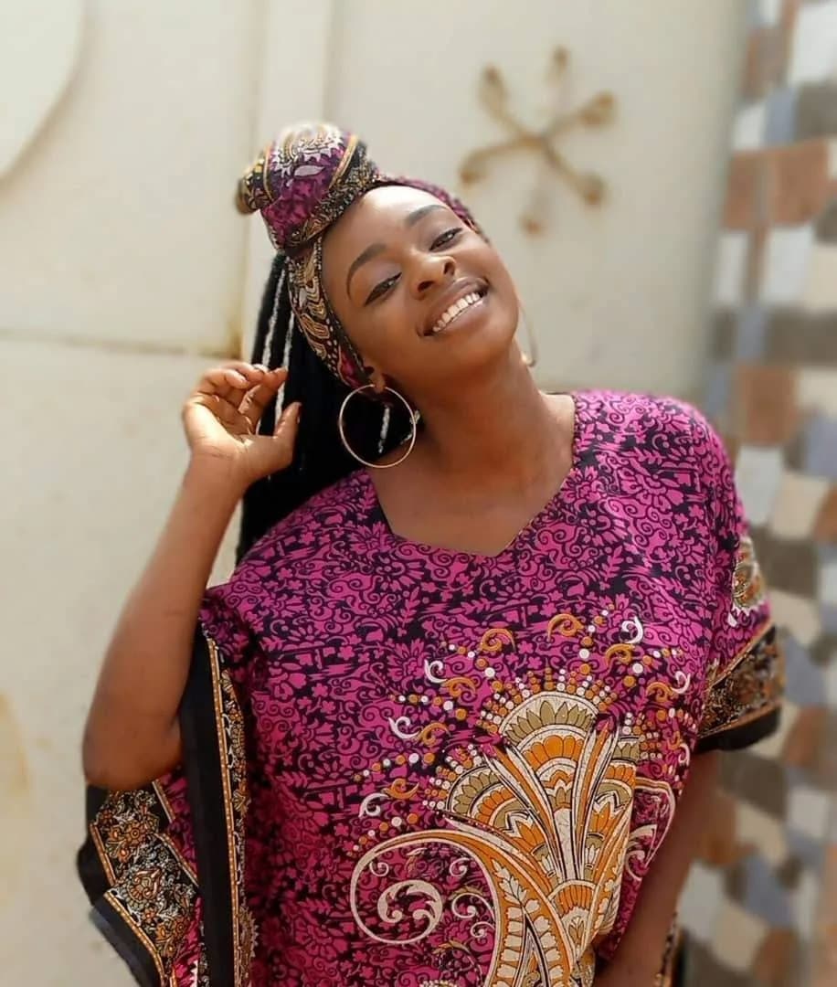 Peace smiling in a colourful wrapper and matching headwrap
