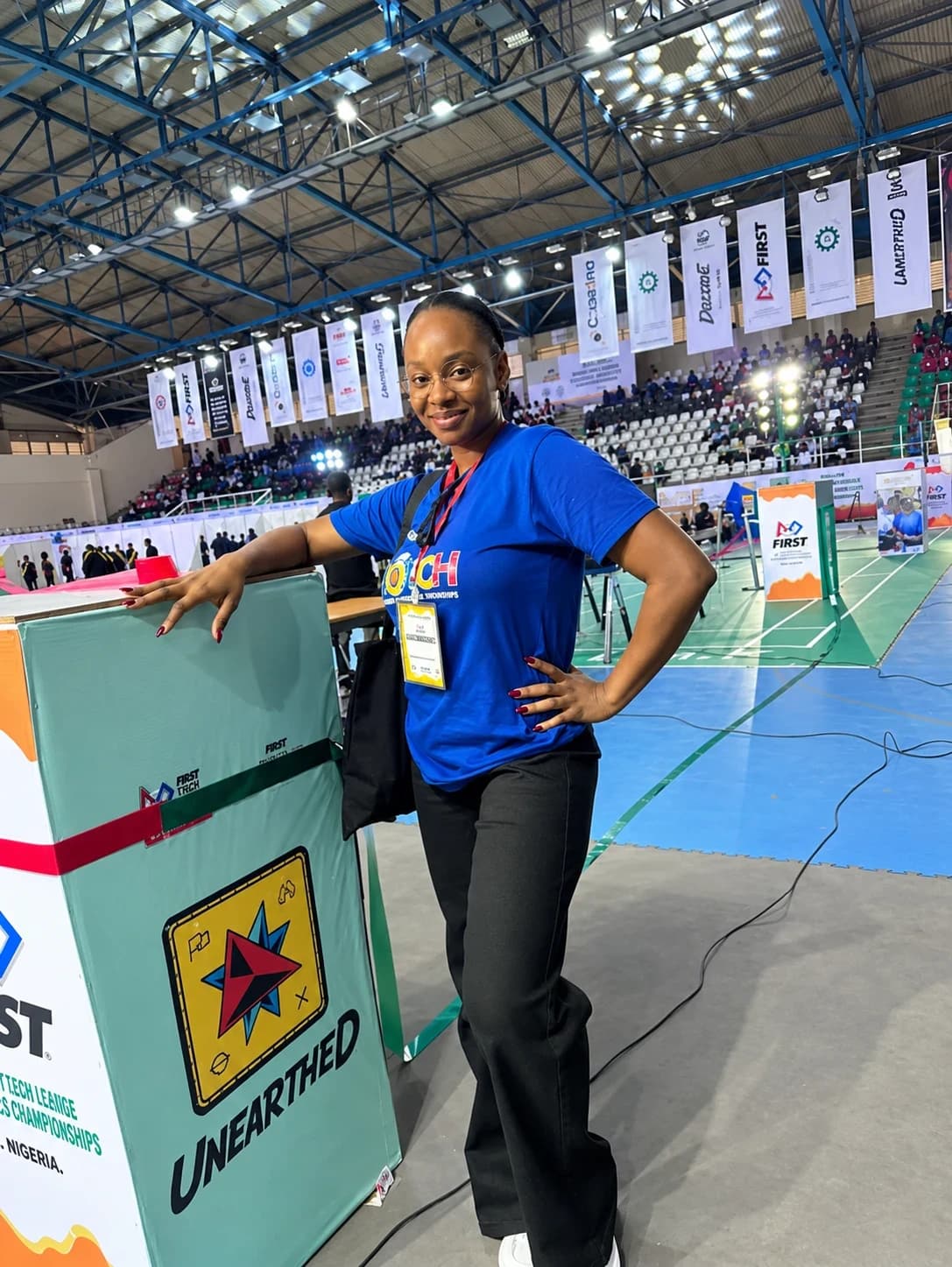 Peace smiling at the National Robotics Championship 2026 in Abuja, wearing her organiser badge